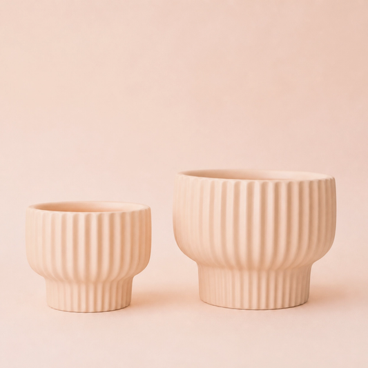 two pale pink ballerina Presley planters of different sizes with a pale pink background