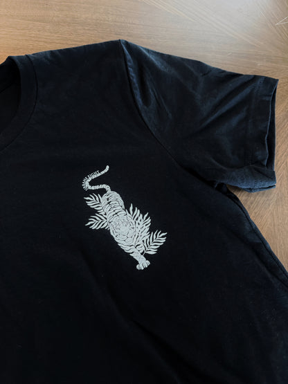 a close up of a black t-shirt with a white tiger on the front