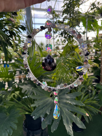 decorative crystal hoop sun catcher with black and white beading and a central large black crystal