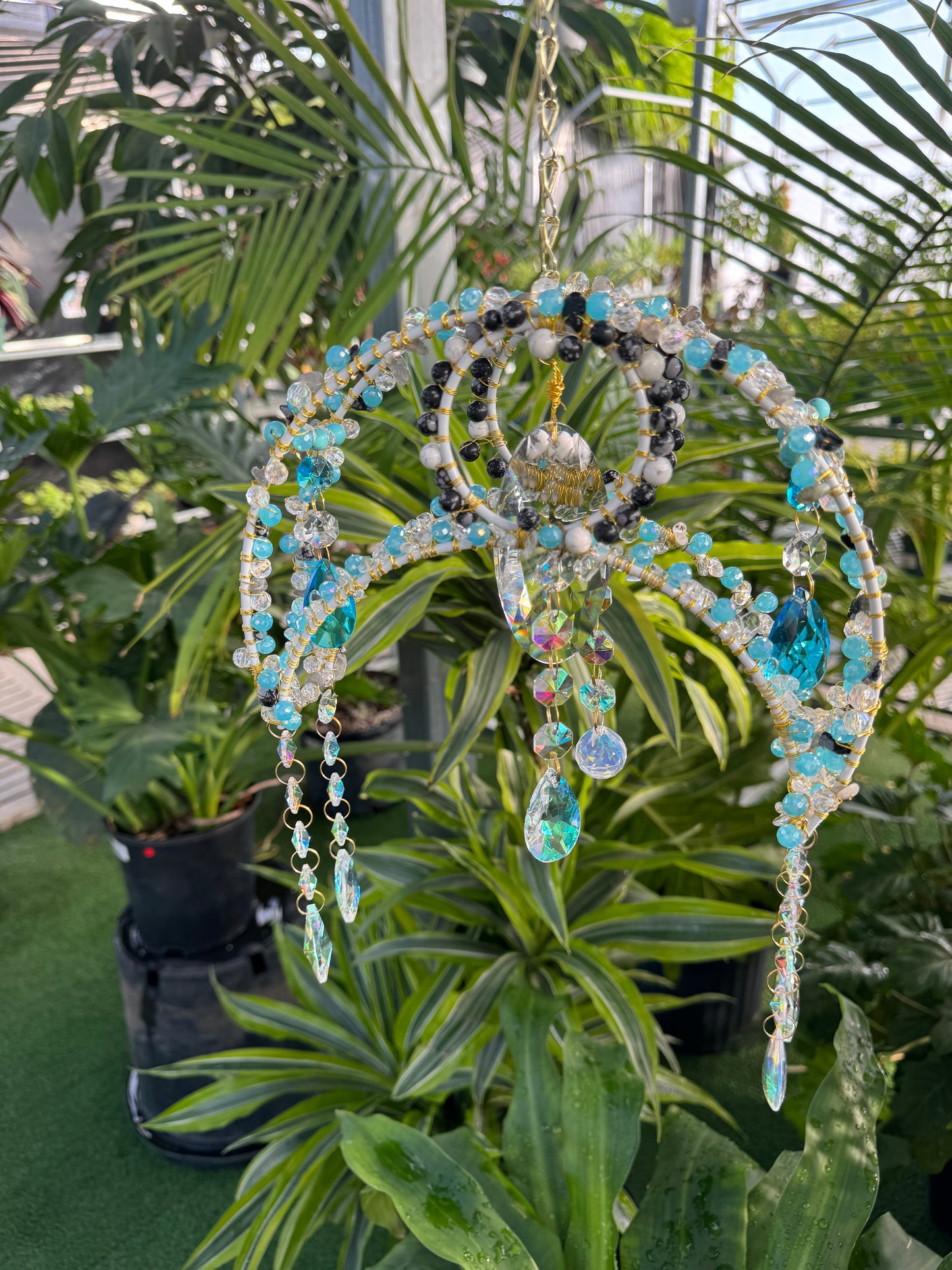 blue and white decorative crystal sun catcher with dangling sparkling crystals