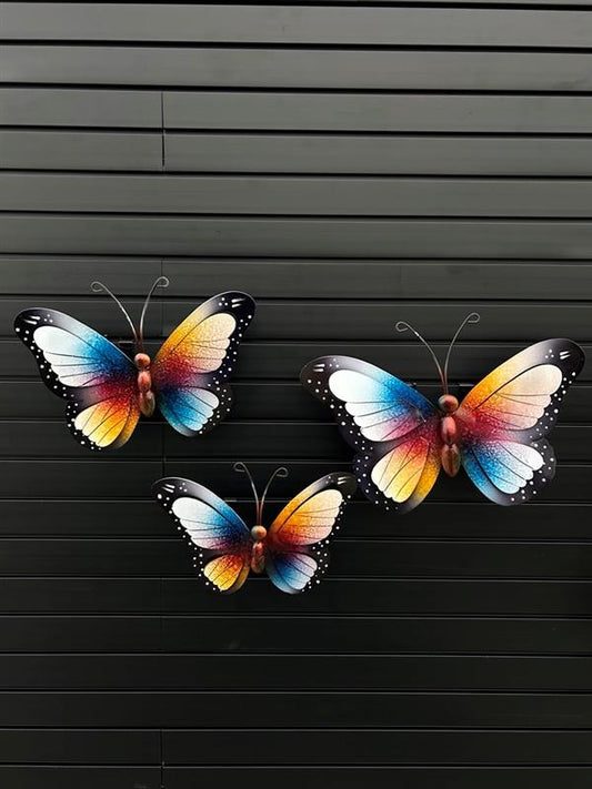A set of three metal decorative butterfly plaques with black backgrounds, featuring multicolored butterfly designs.