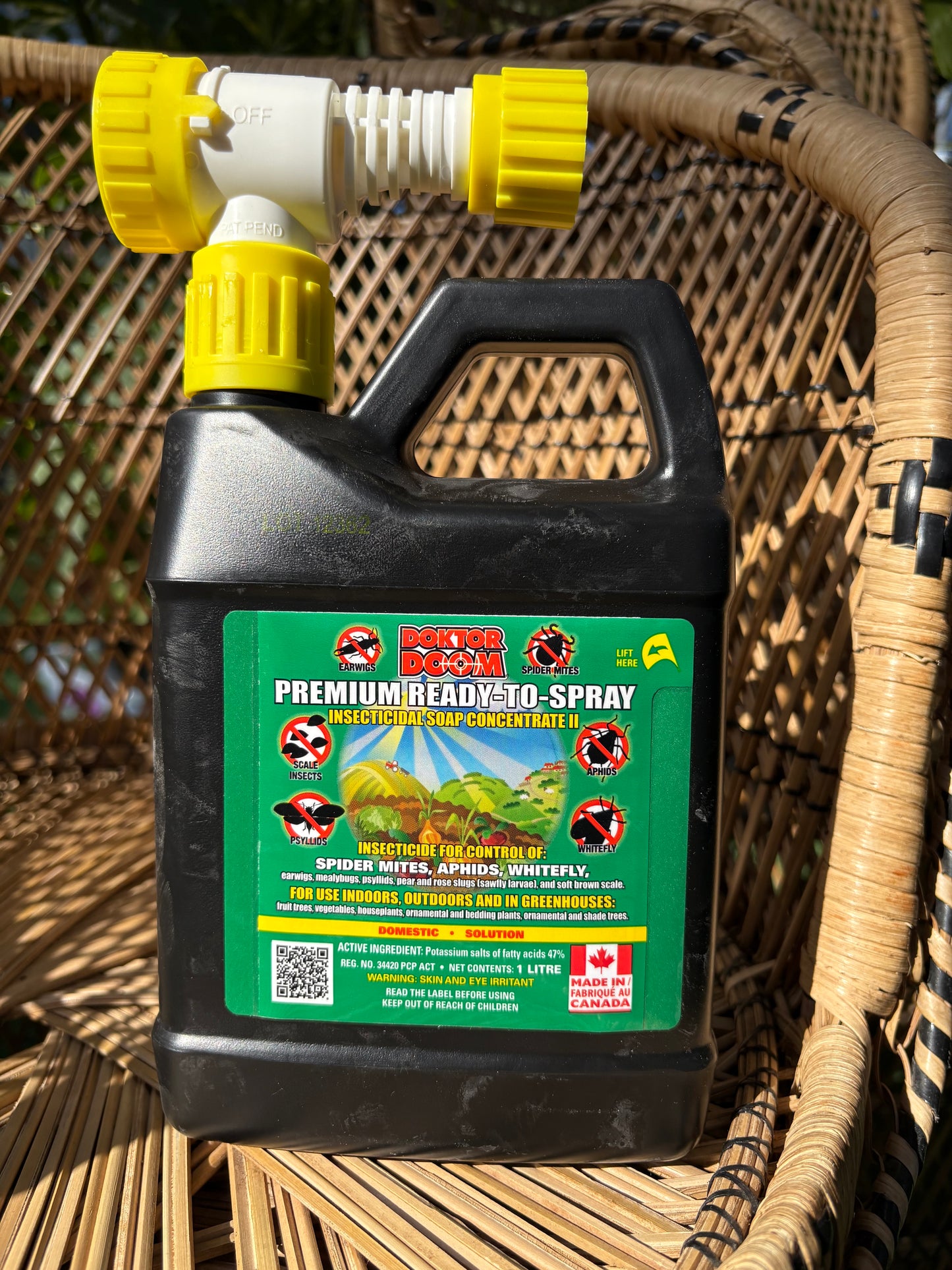 a picture of doktor doom premium ready to spray insecticidal soap concentrate sitting on a wicker chair in a greenhouse 