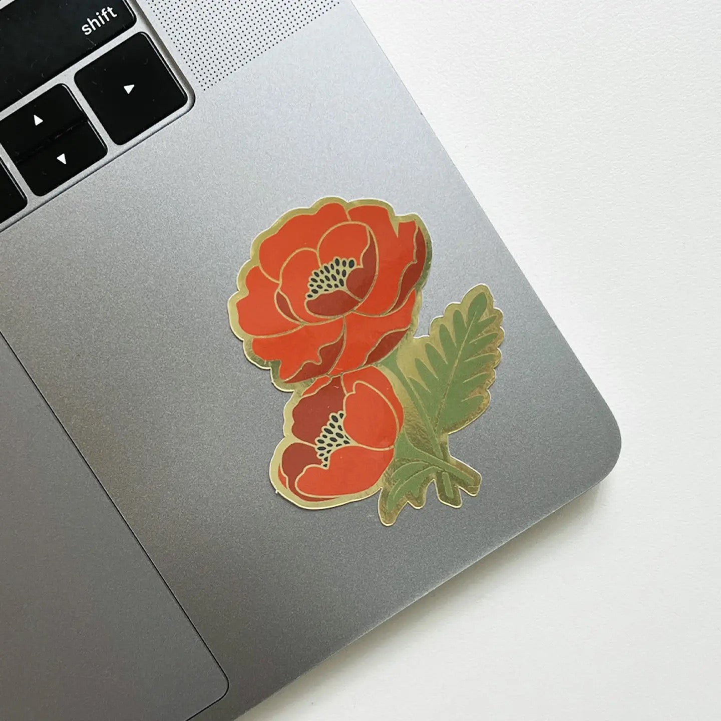 Red Floral sticker on a laptop on white background