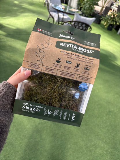 Revita-Moss packaging held by a person on a grassy background