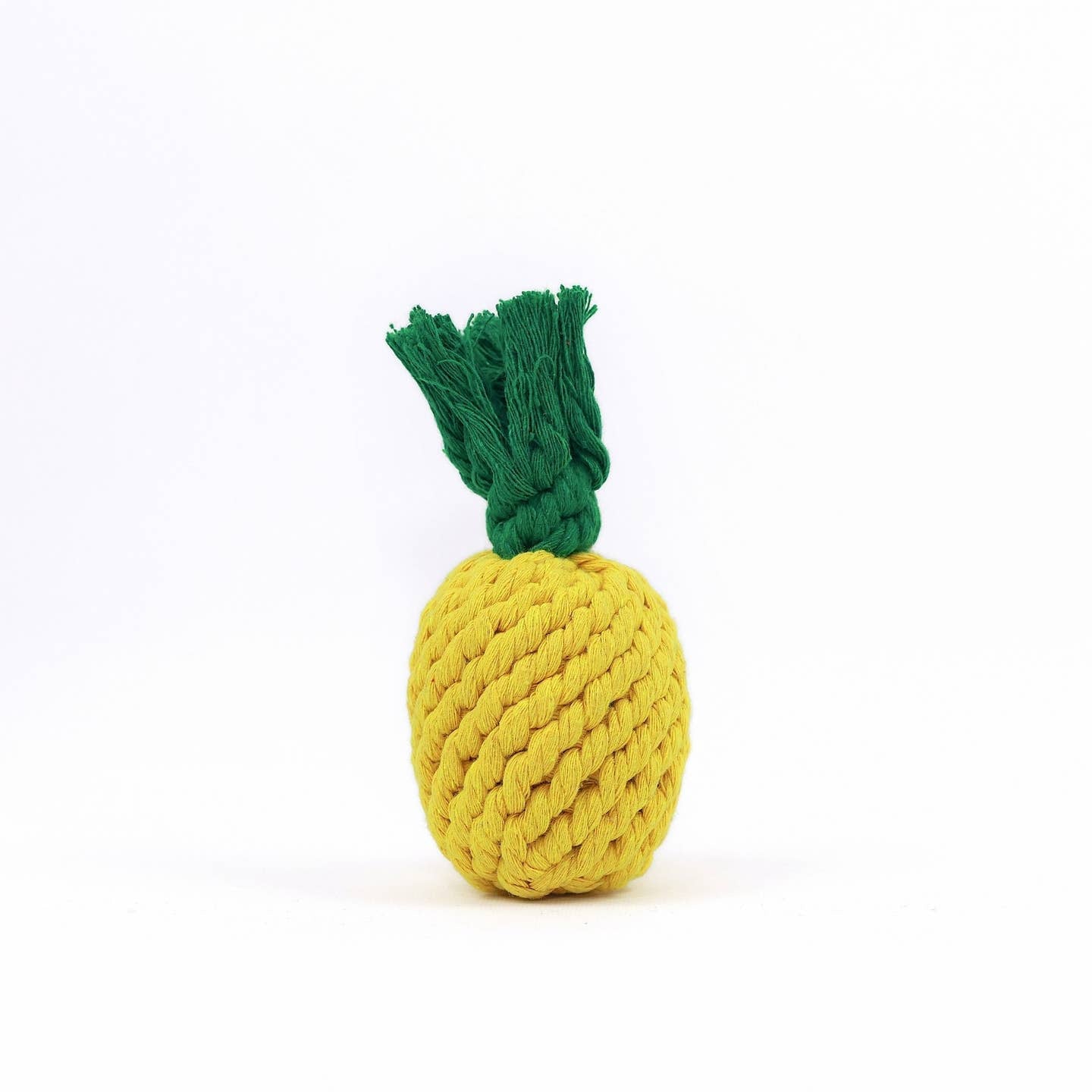 A handmade macrame rope toy shaped like a pineapple with a green top.