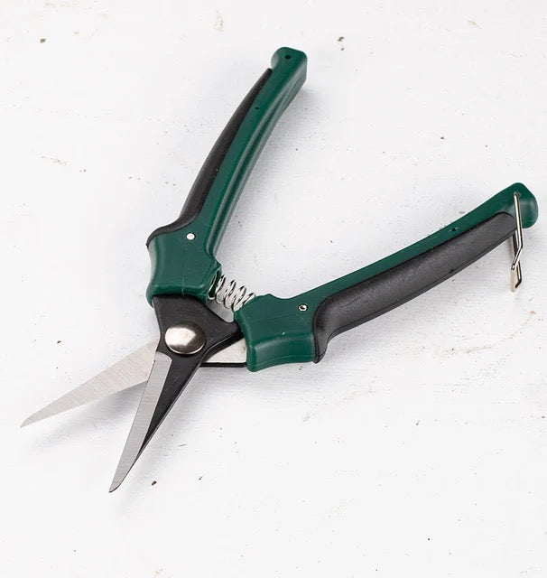 Gardening shears with green and black handles on a white background