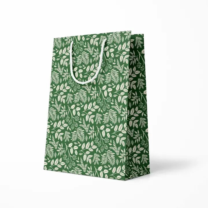 Green gift bag with white leaf pattern on a white background