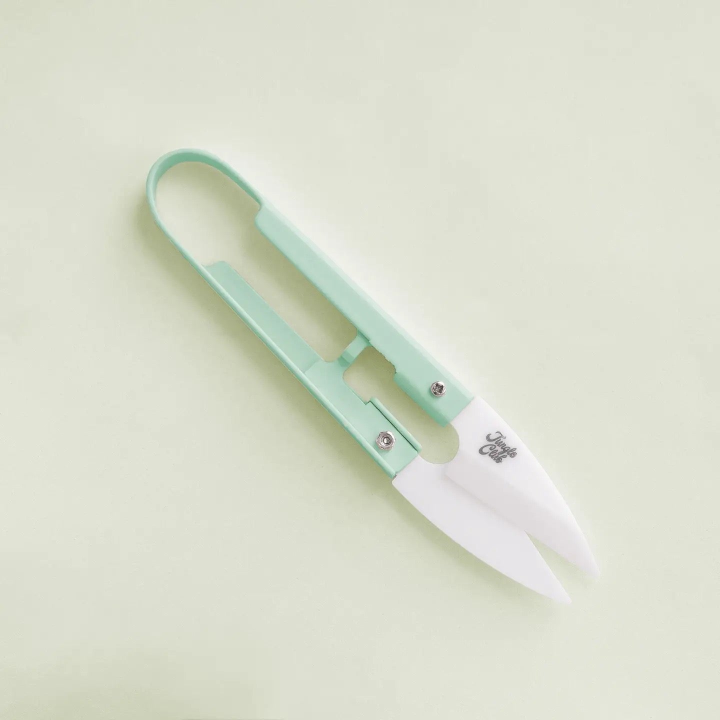 a pair of green plant snips against a green background