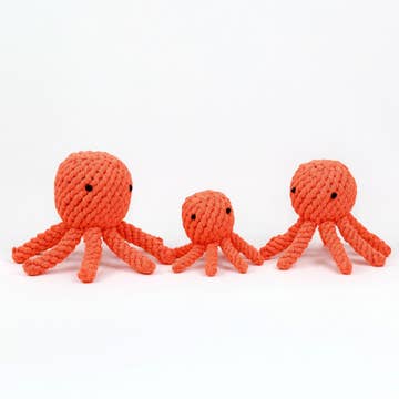 a set of three orange woven octopus pet toys on white background