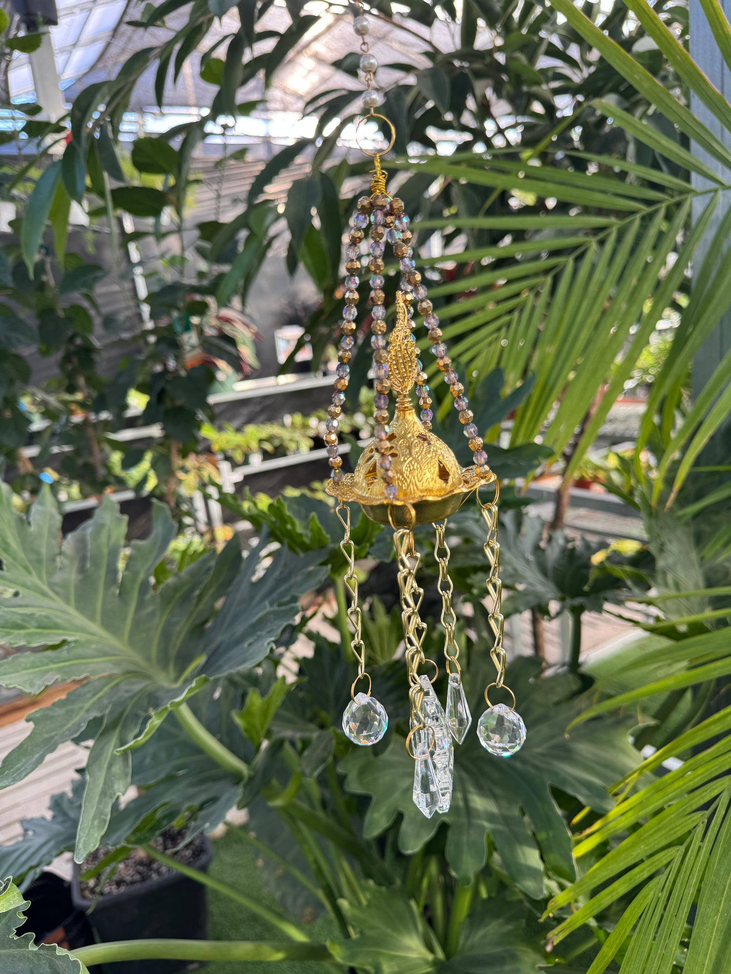 gold incense burner sun catcher with a gold centre and clear crystals hanging from the base