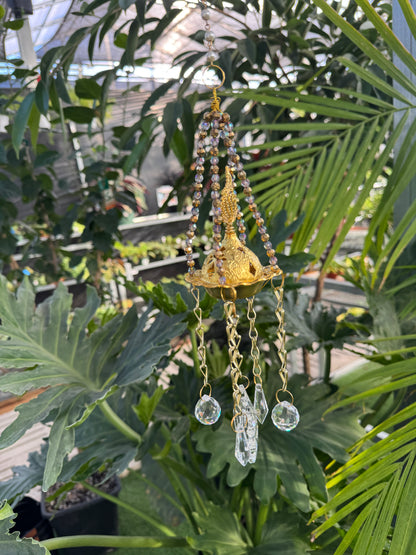 gold incense burner sun catcher with a gold centre and clear crystals hanging from the base
