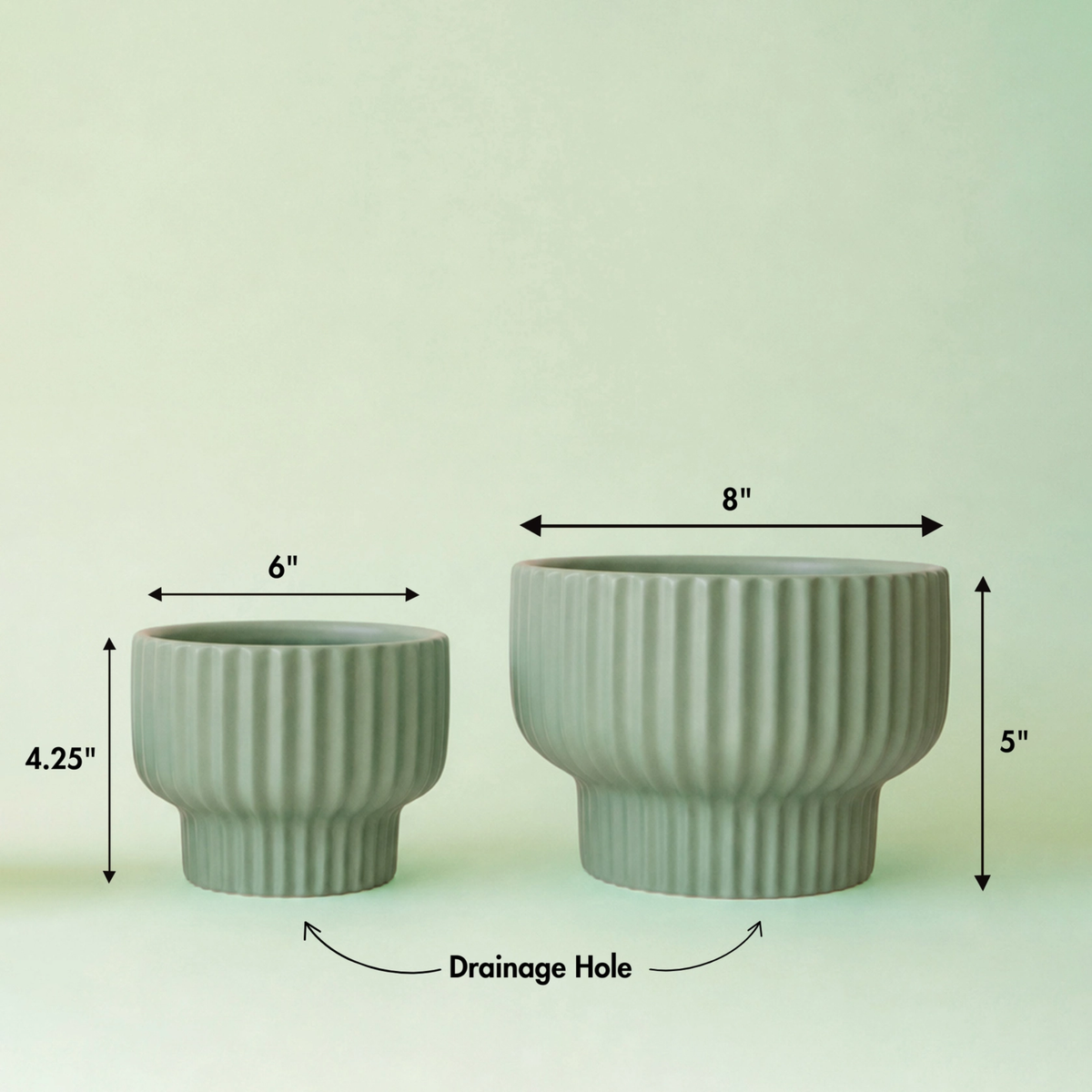 two jade coloured pedestal Presley planters with black test on the image showing the measurements of the pots against a jade background