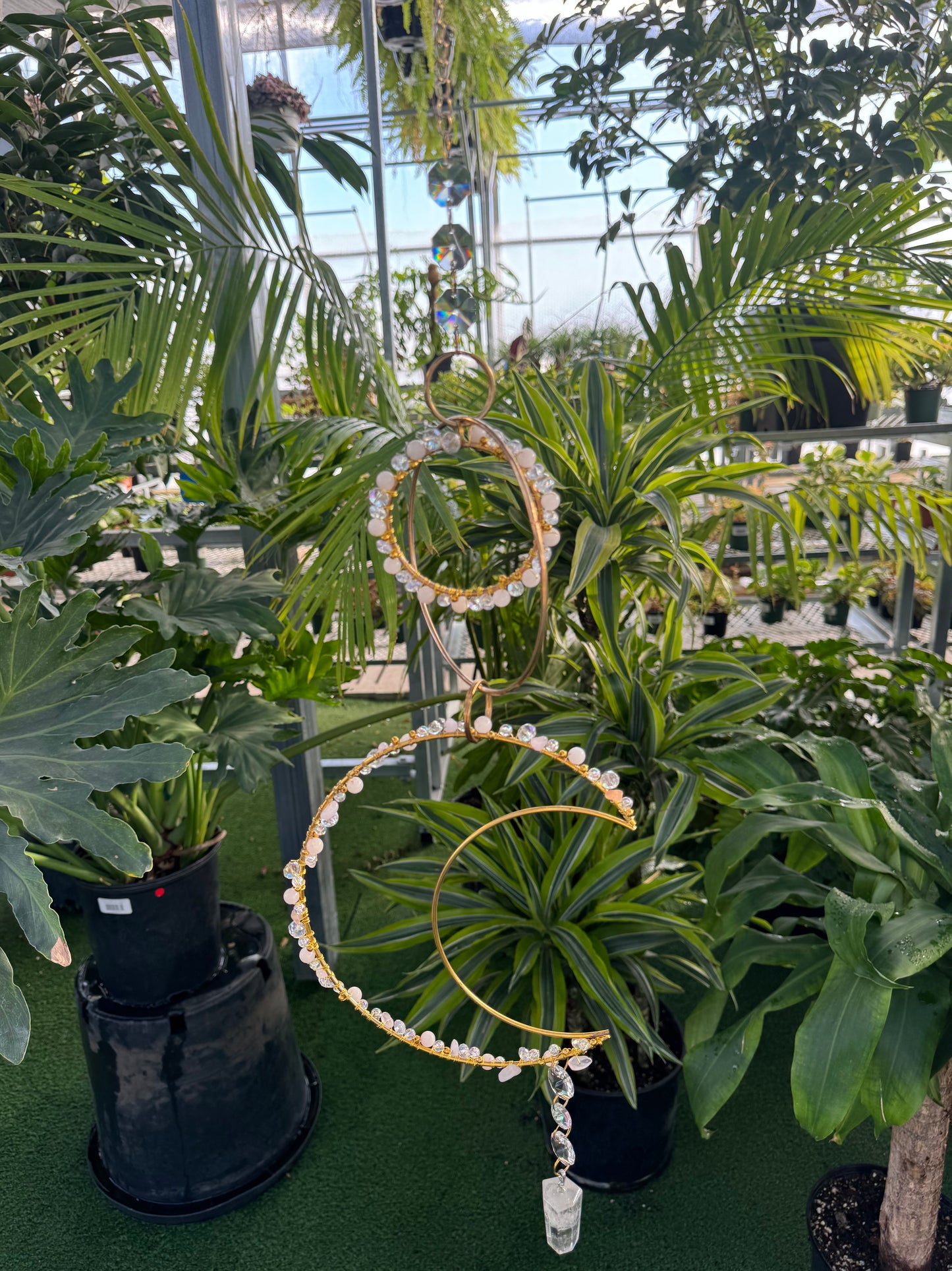decorative crystal sun catcher with rings and a large moon beaded with white beads