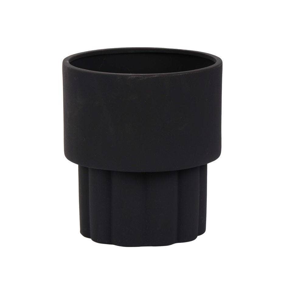 A matte black ceramic planter with a cylindrical shape and ribbed texture on the outside.