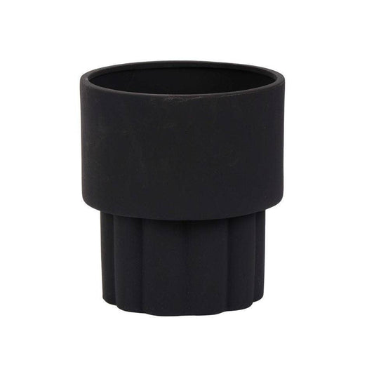 A matte black ceramic planter with a cylindrical shape and ribbed texture on the outside.