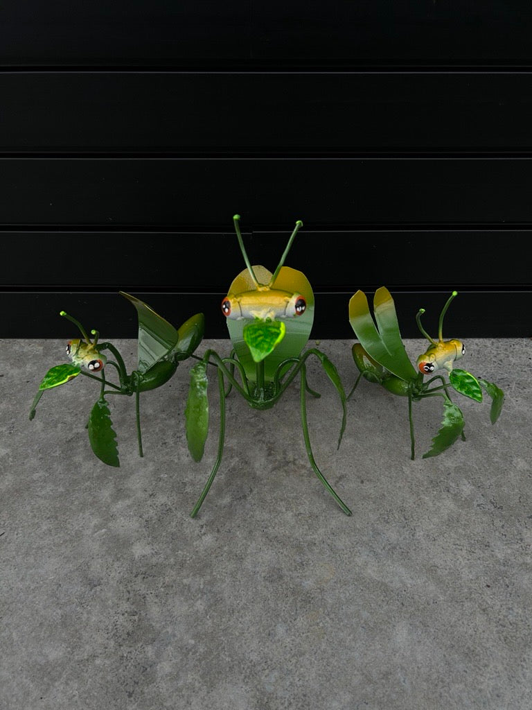 A set of decorative metal garden bugs with green and yellow colors, designed for outdoor use.