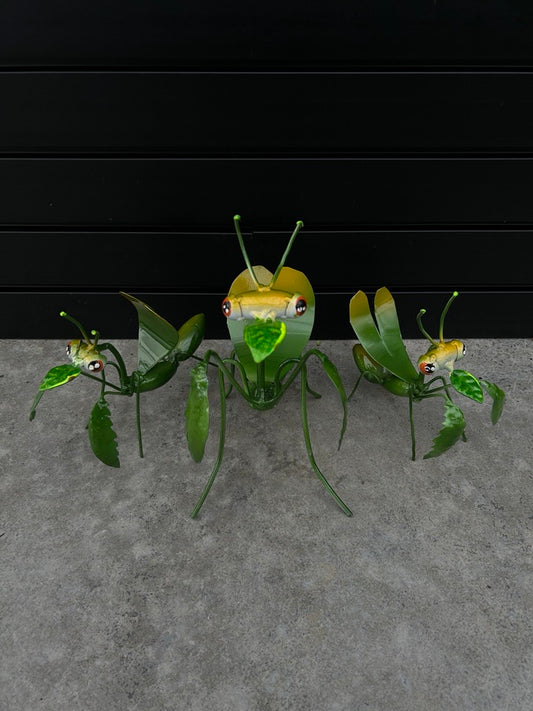 A set of decorative metal garden bugs with green and yellow colors, designed for outdoor use.