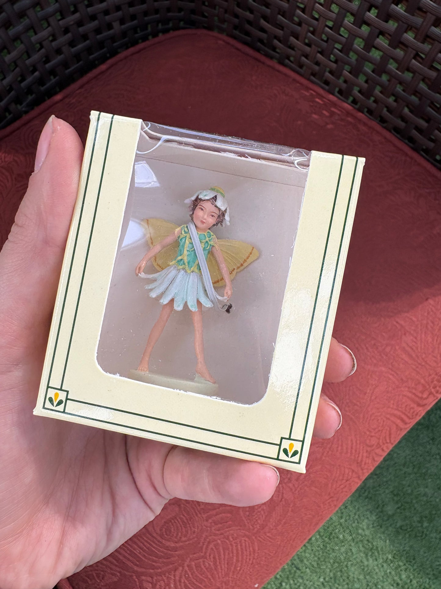 hand holding a package of a mini garden fairy