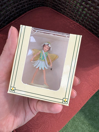 hand holding a package of a mini garden fairy
