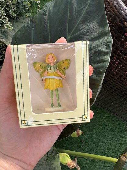 a small fairy figurine in plastic packaging