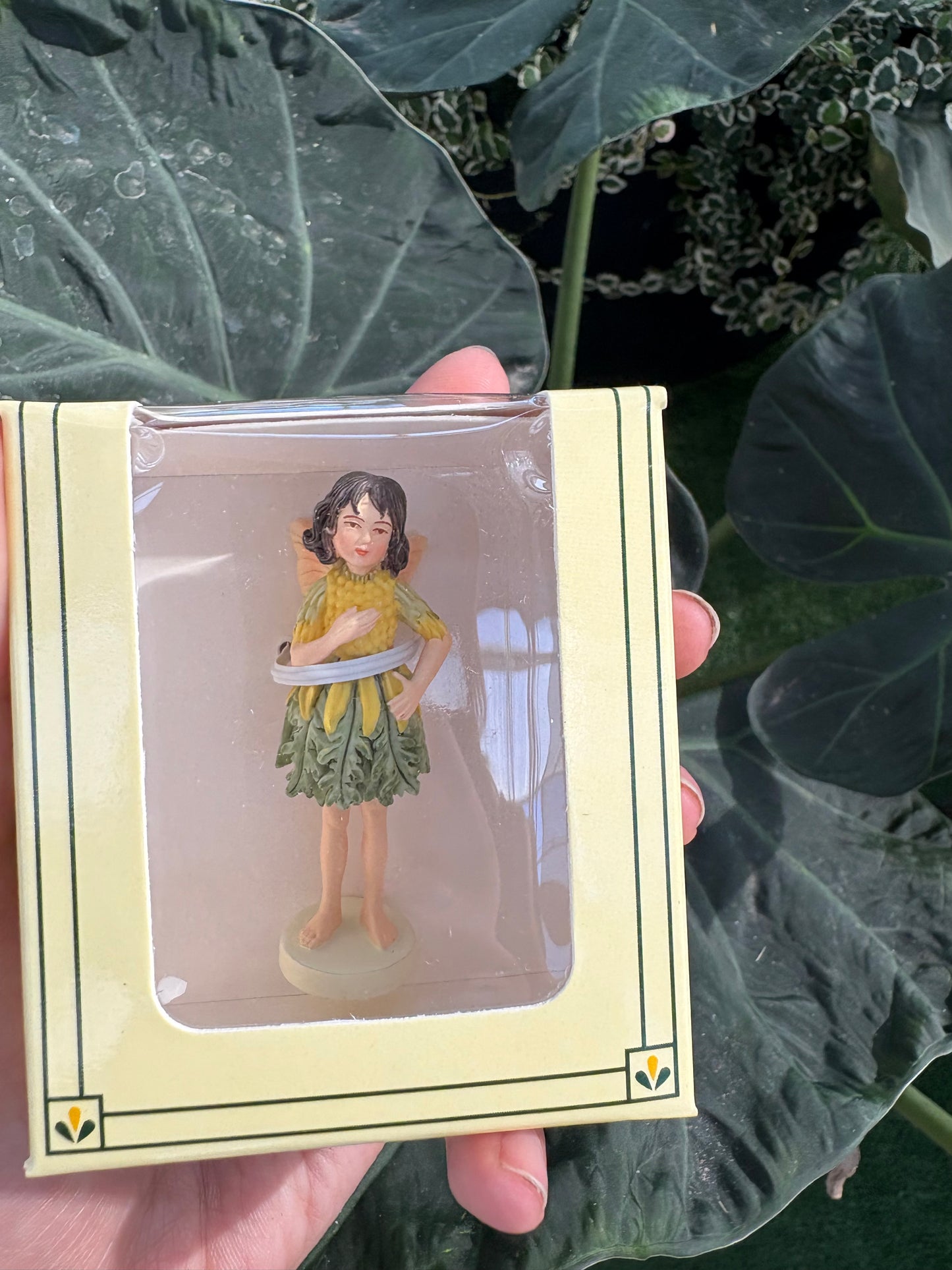 a small yellow dressed fairy in clear packaging