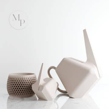 2 geometric white watering cans of different sizes against a white background