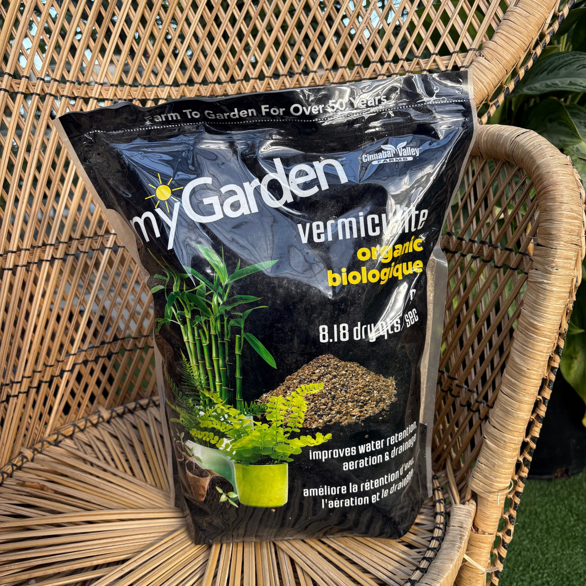 a black back labelled my garden vermiculite organic with images of plants on the package with the bag resting on a wicker chair