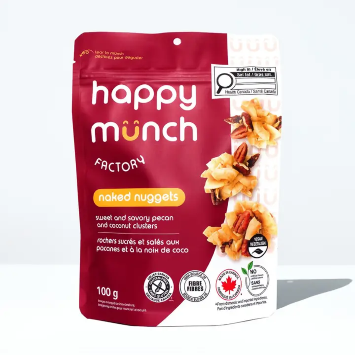 a red package of happy munch factory naked nuggets sweet and savoury pecans with images of pecan clusters with a white background
