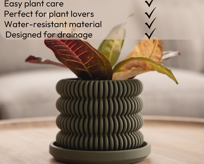 a green textured pagoda pot holding a plant with words above specifying its qualities