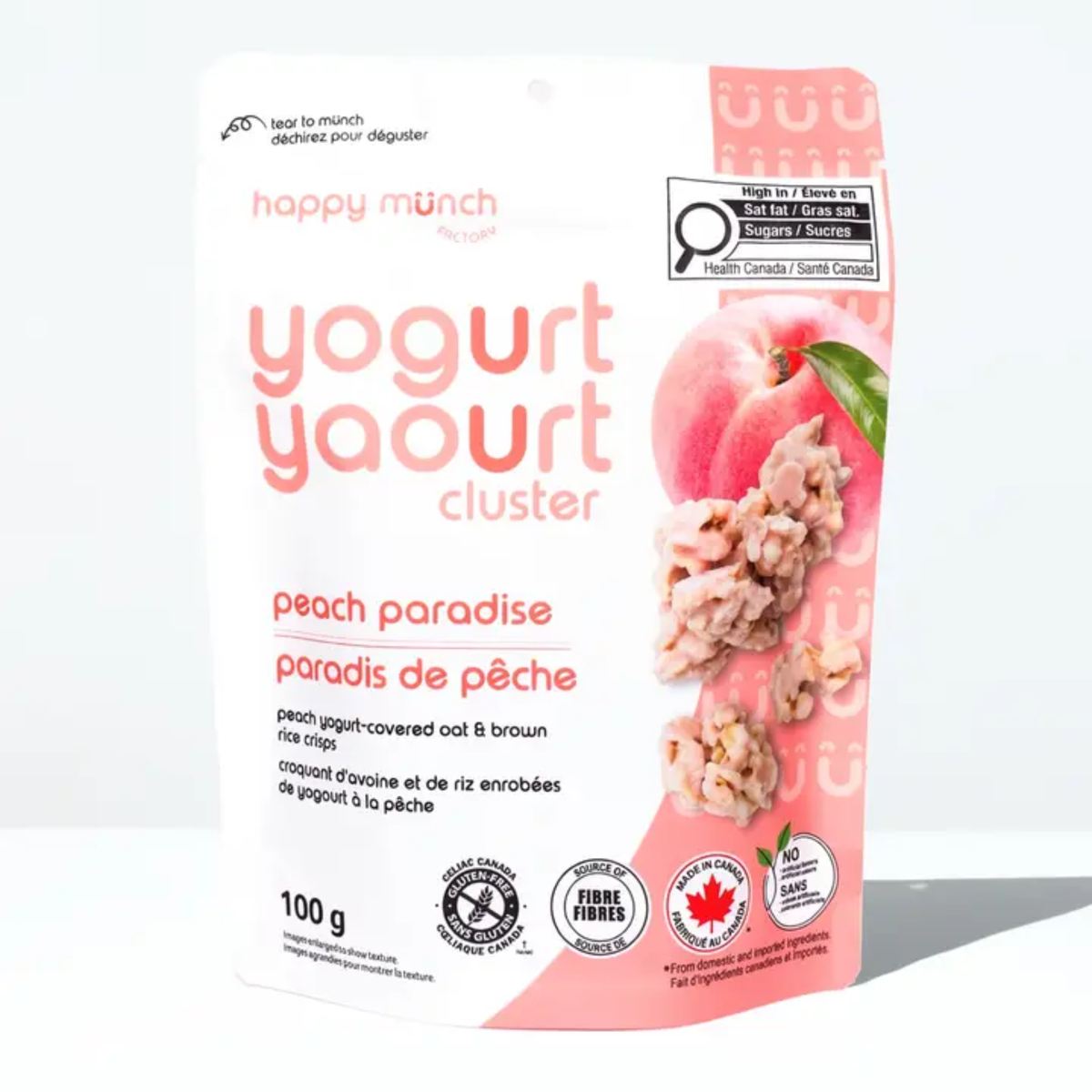 a package with a peach coloured side of happy munch yogurt clusters peach paradise with an image of a peach and clusters against a white background