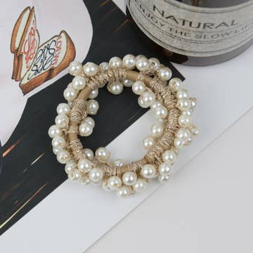 a pearl scrunchie resting on a table