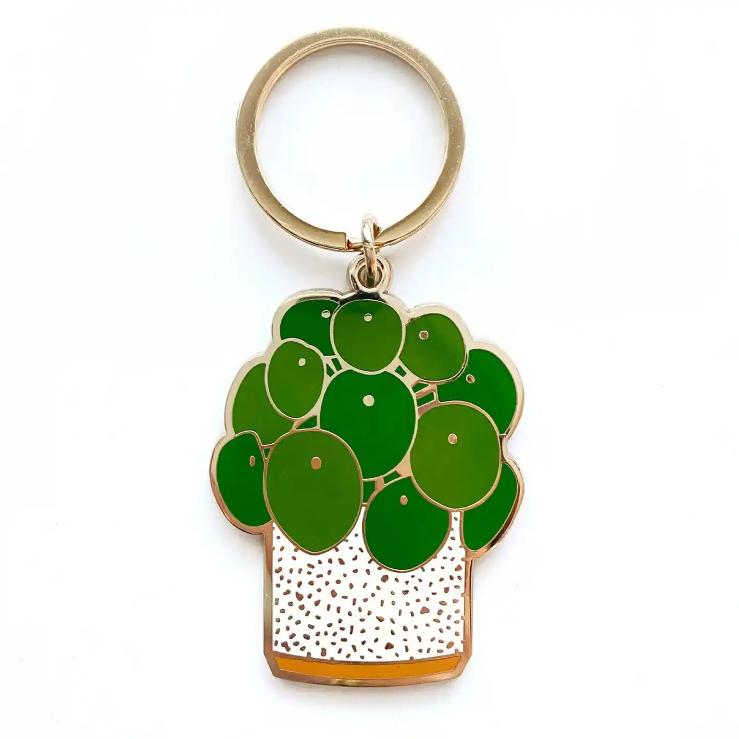 a gold keychain with a pilea plant design on a plain background