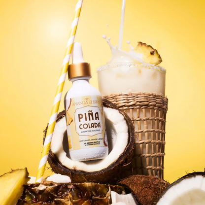 a white dropper bottle with a yellow label that says Pina colada mushroom mocktail with the bottle resting in an open coconut with a Pina colada drink behind it with a yellow background
