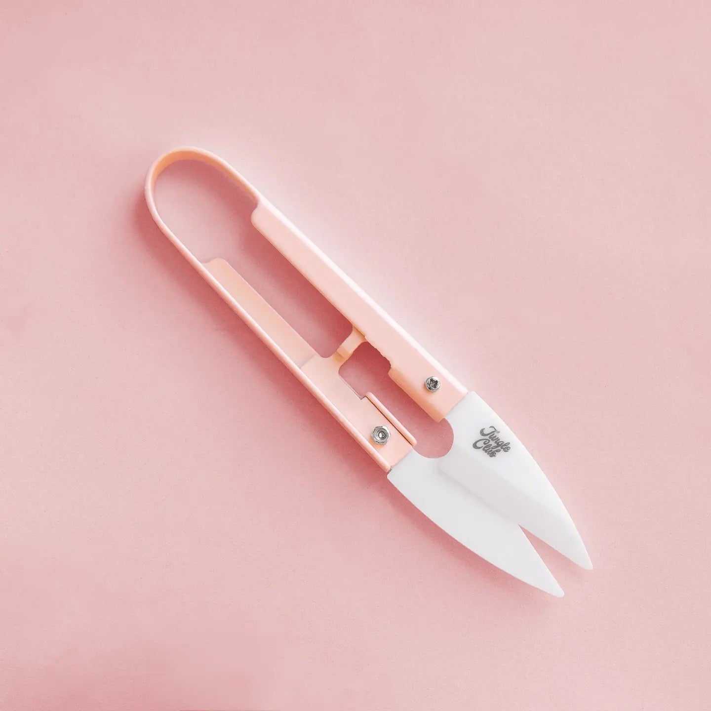 a pair of pink plant snips against a pink background