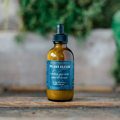 a brown dropper bottle with a blue label that says plant elixir