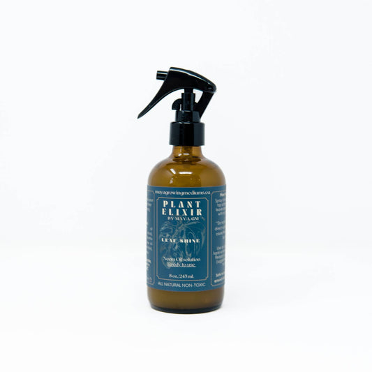 A 16 oz / 500 ml spray bottle of Plant Elixir Leaf Shine with a black spray nozzle. The label is blue with white and green text, and it is displayed against a white background.