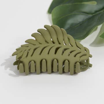 an olive green plant themed hair clip against a white background