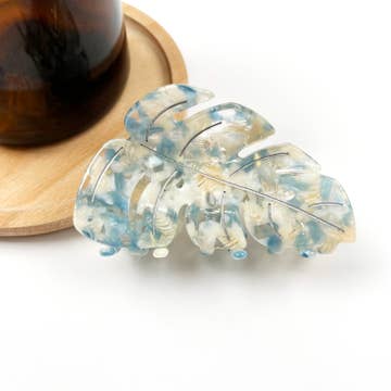 a blue and white plant themed hairlip against a white background
