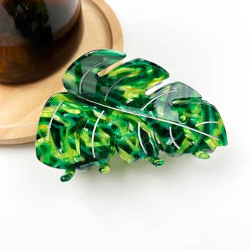 a plant themed green hairclip on a white background
