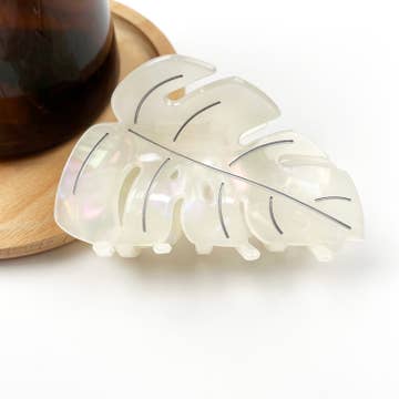a white plant themed hair clip against a white background