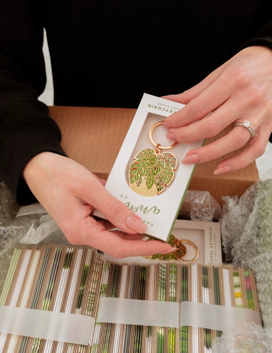 hands holding a plant style keychain