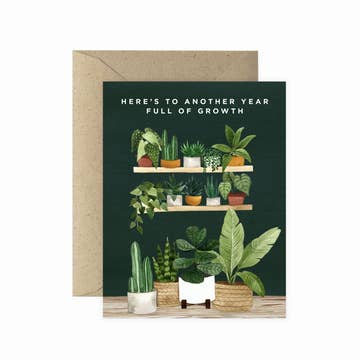 a plant themed card that says here's to another year full of growth on a white background