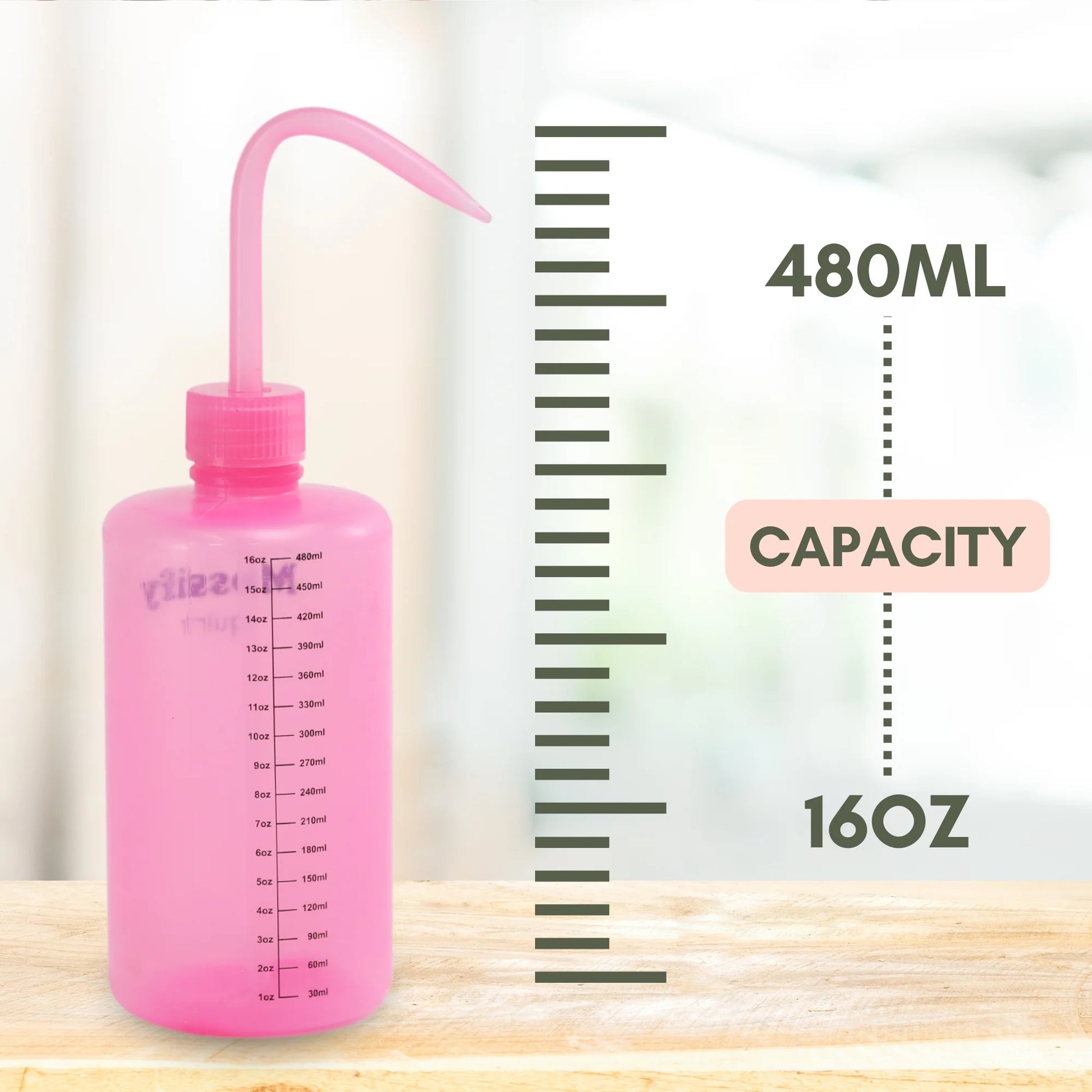 Pink squeeze bottle with measurement markings on a wooden surface