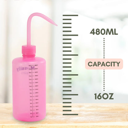 Pink squeeze bottle with measurement markings on a wooden surface