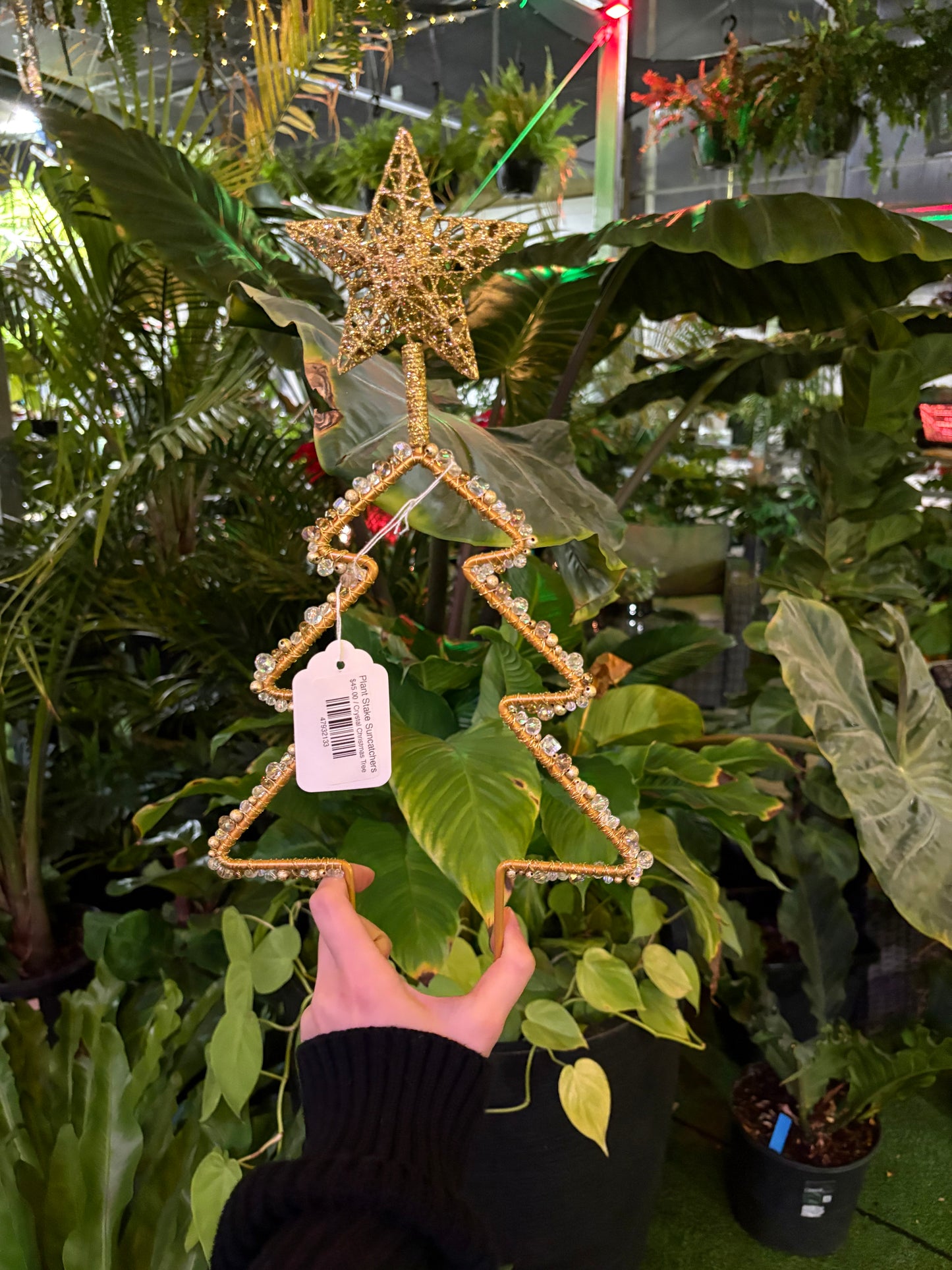 decorative plant stake sun catcher in the shape of a christmas tree with a gold star on top