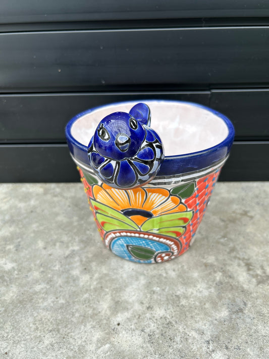 ceramic colourful pot with ceramic blue bird on top