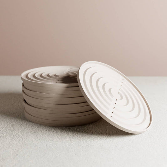 stack of white durable plant drip trays