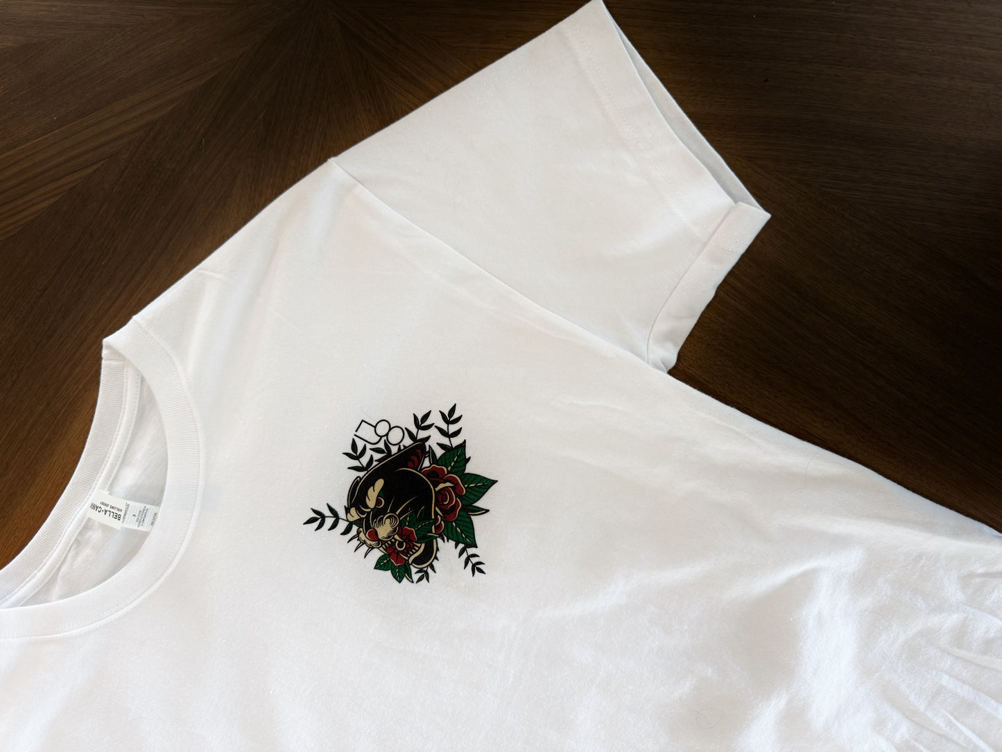 a white t-shirt with a traditional tattoo style panther