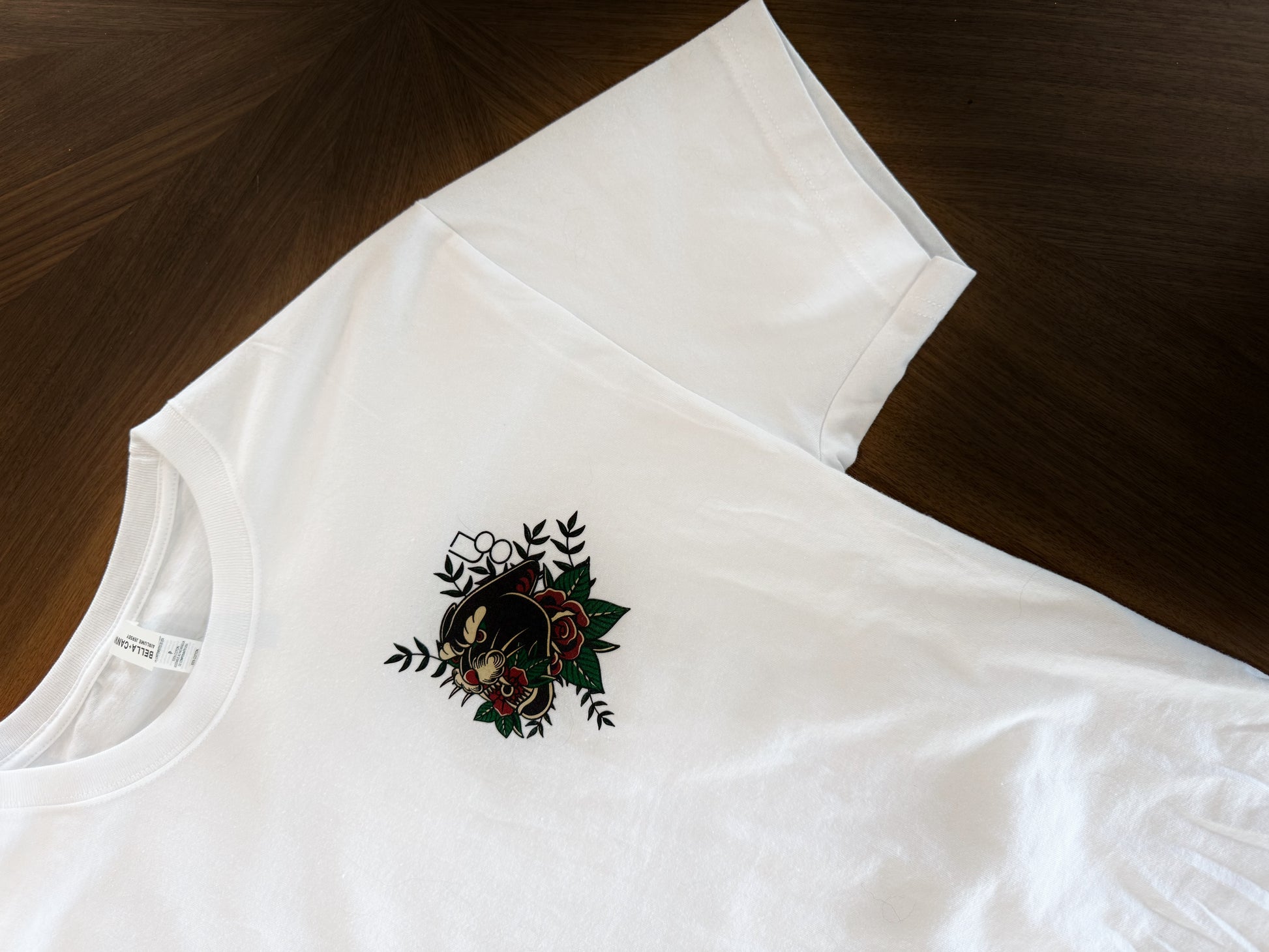a white t-shirt with a traditional tattoo style panther