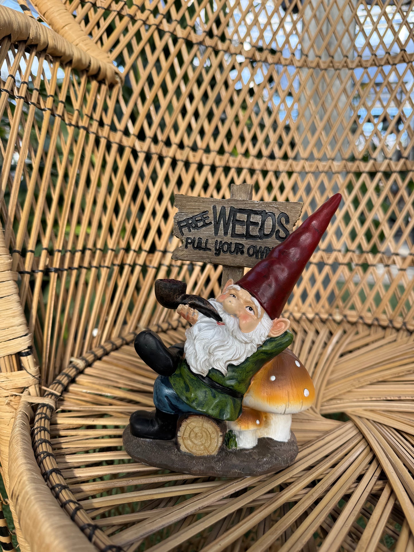 Gnome figurine with a sign on a woven surface
